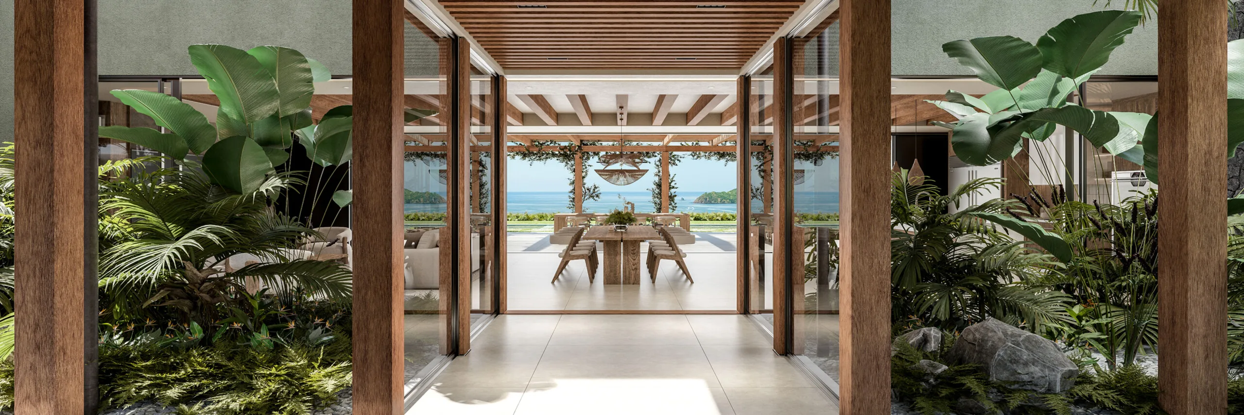 Tropical courtyard entrance at Casa Uno showcasing lush interior greenery and a direct line of sight to the bay